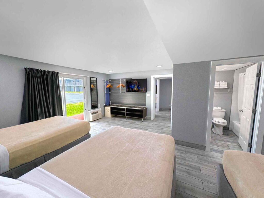 Quarto reformado do Celebration Suites, com piso laminado e mobiliário atualizado